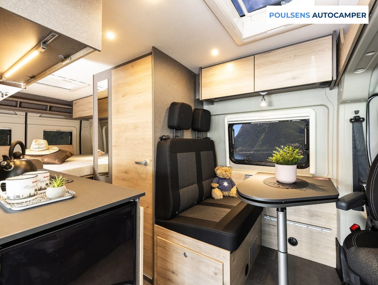 Salon intérieur du camping-car urbain Dethleffs Globetrail 640 ES 2026 avec banquettes confortables et table centrale